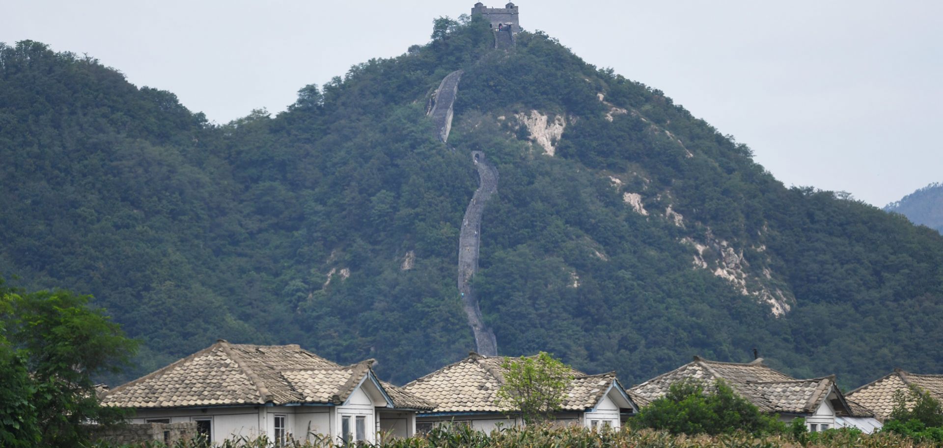 North Korean houses rest in front of the Great Wall of China near the town of Sinuiju.