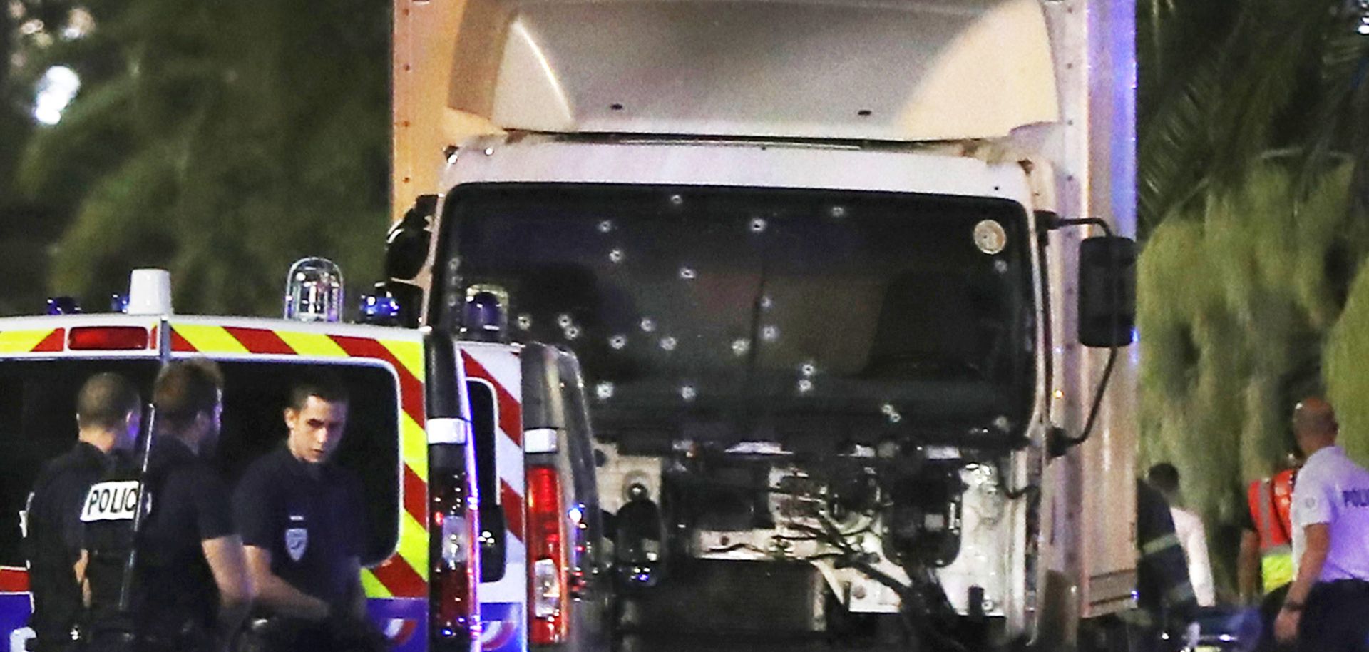 Police officers stand near the truck used to plow through a crowd in Nice, France, on July 14. Based on the rampage's success, the Islamic State's Rumiyah magazine has encouraged the group's followers to conduct more attacks using large, paneled trucks.