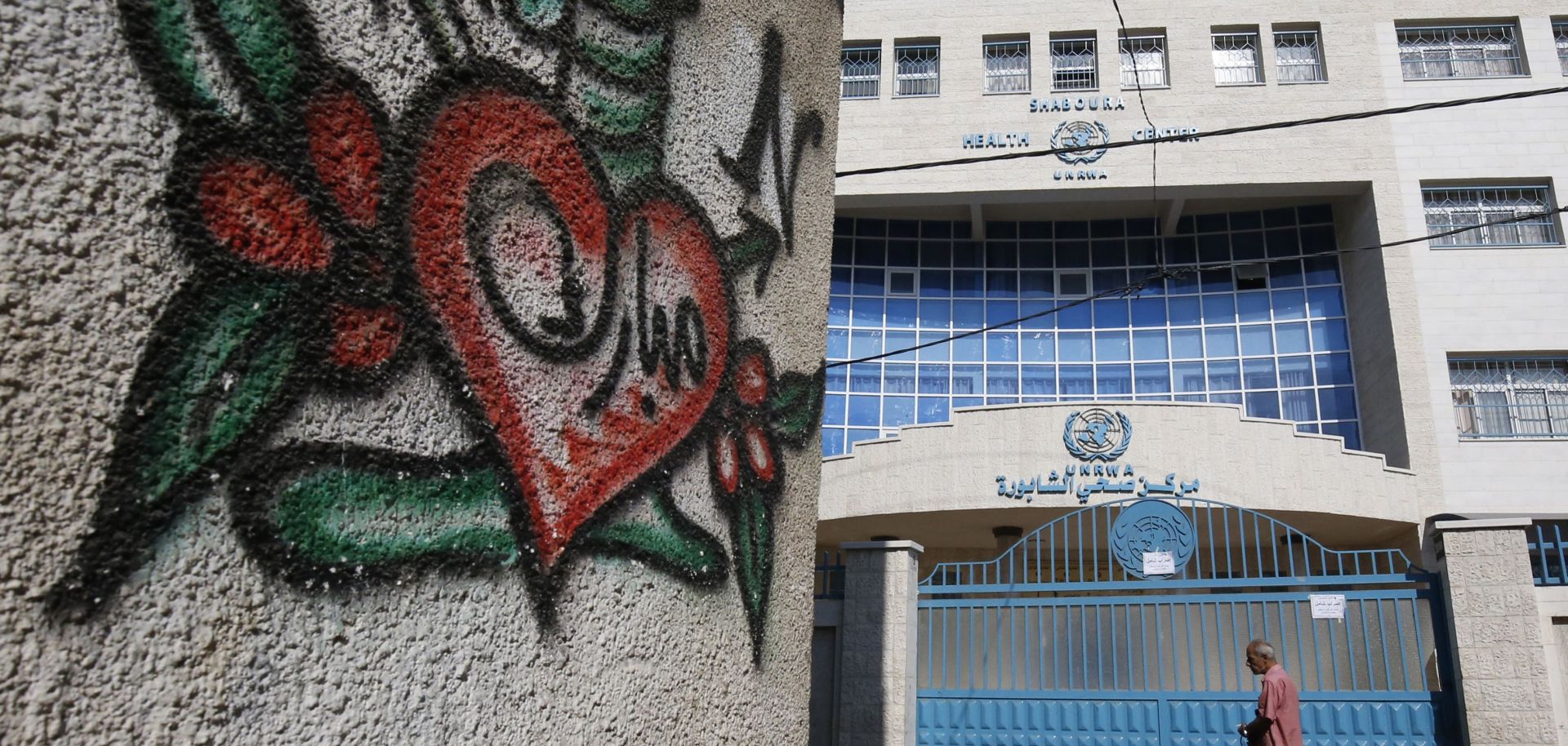 A Palestinian man walks past a shuttered health center provided by the United Nations Relief and Works Agency (UNRWA) during a strike of all UNRWA institutions in Rafah in the southern Gaza Strip on Sept. 24.