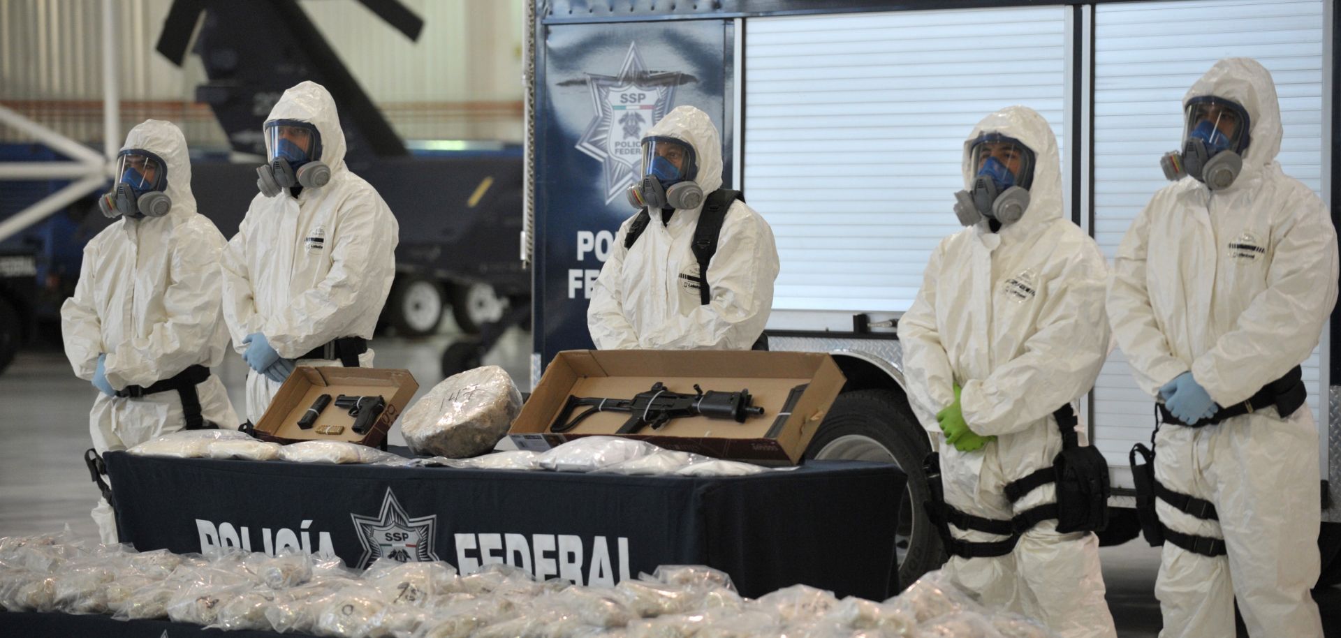 Mexican police shows off seized drugs and weapon to member of the media on February 14, 2012, in Mexico City.