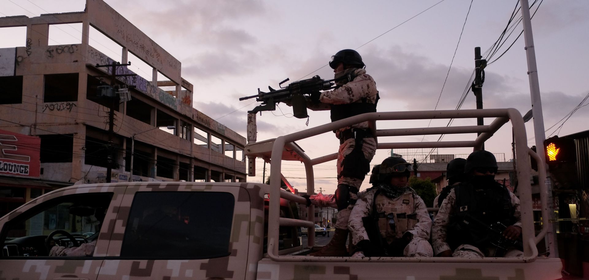 Mexican Soldiers leave the scene of a crime where a man was killed by gun fire in downtown Tijuana.