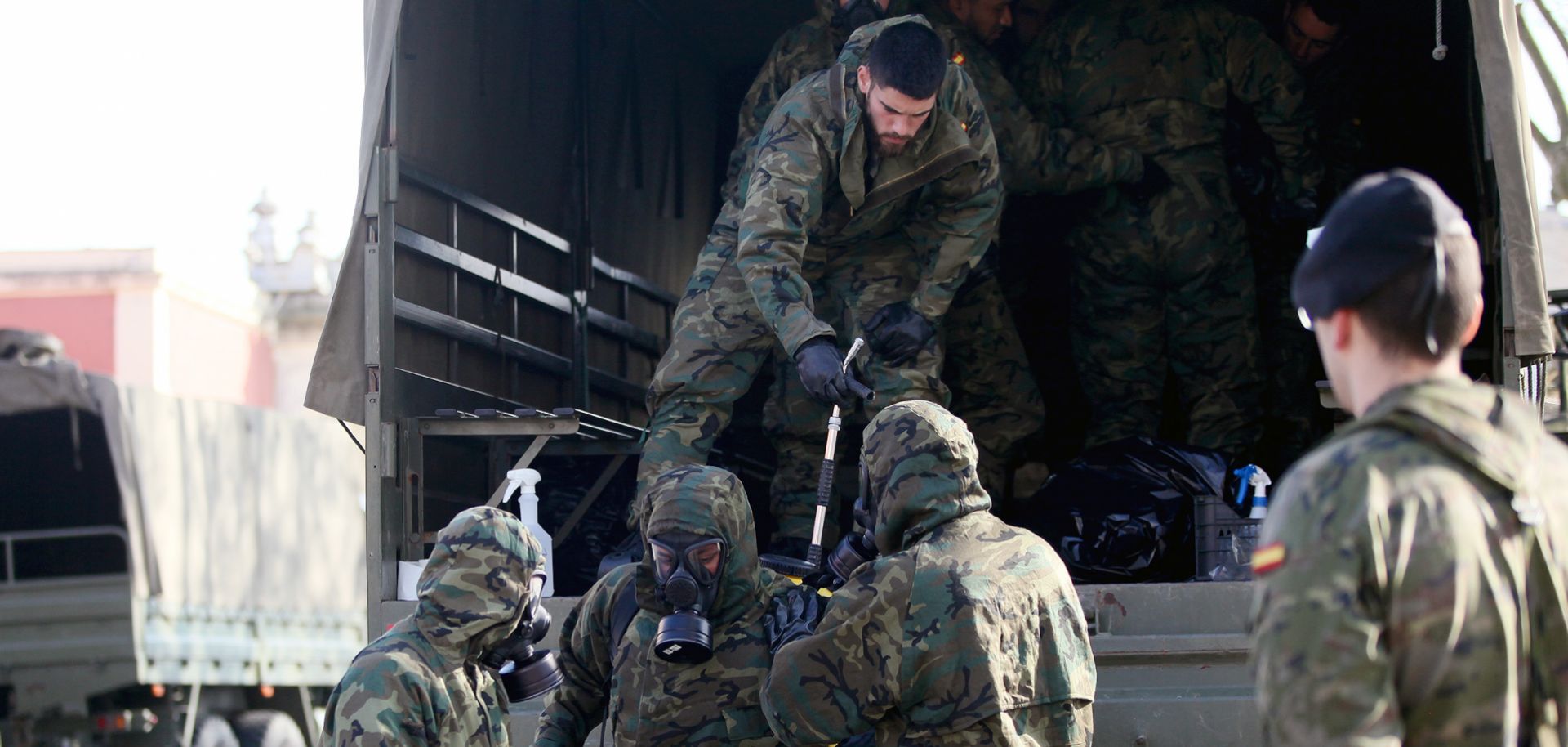 Fully protected members of the Spanish Army's Nuclear Bacteriological and Chemical Regiment (RNBQ) prepare to disinfect a train station in San Sebastian to prevent the spread of the coronavirus on March 24, 2020.