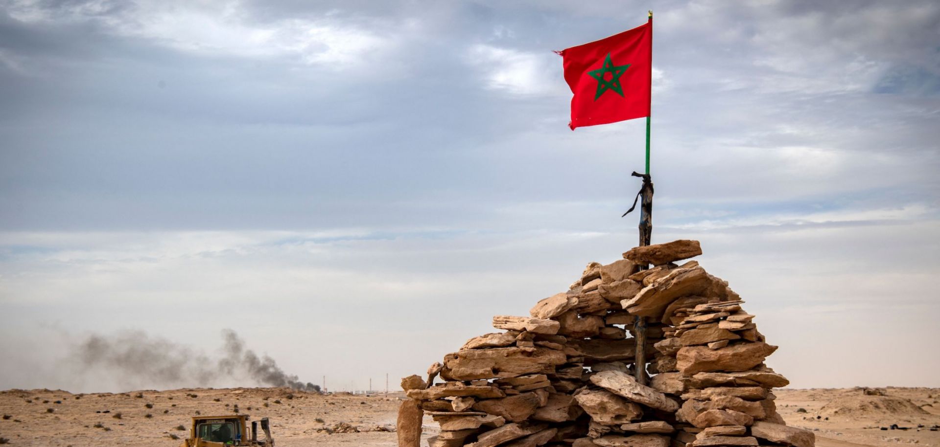 A bulldozer passes by a hilltop manned by Moroccan soldiers in Western Sahara on Nov. 23, 2020.