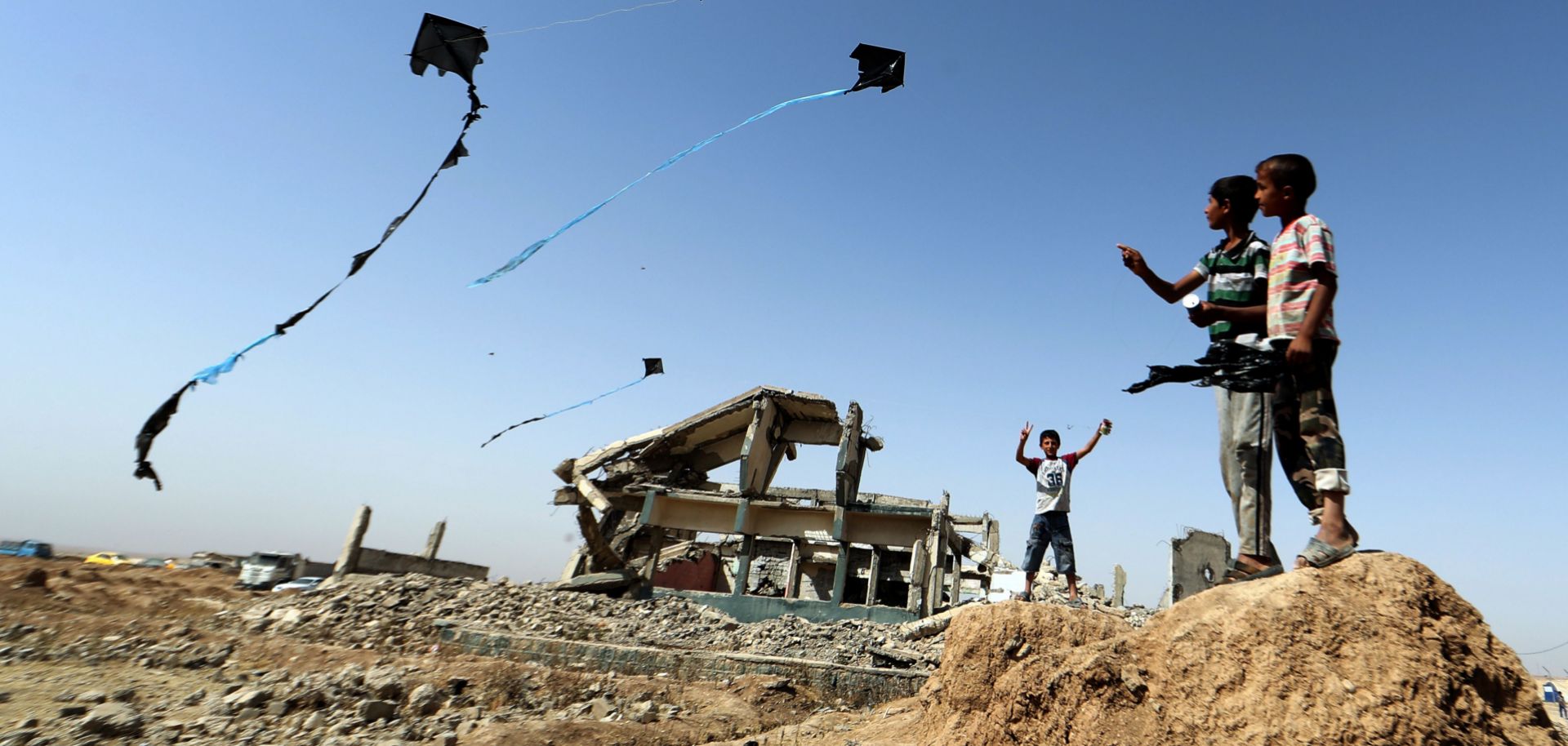 Children who lived in Mosul play at their temporary home in a camp for people displaced from the war-scarred city.