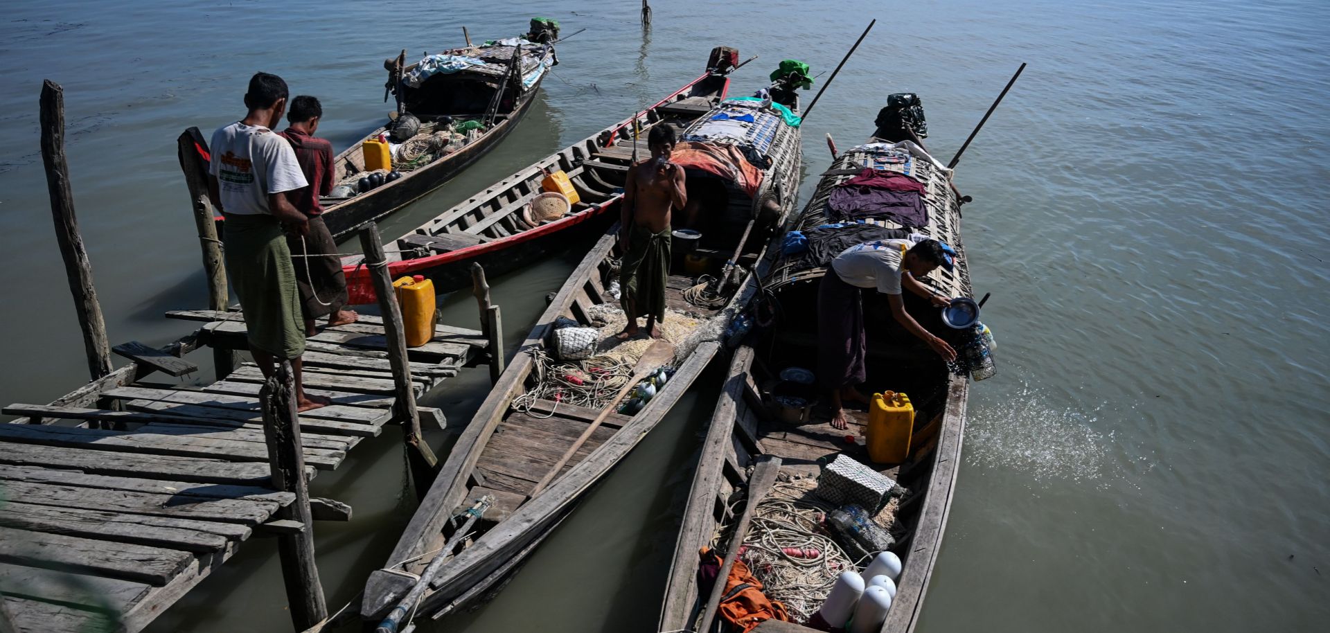 This photo taken on Oct. 2, 2019, shows fishermen boarding their boats at a small jetty on Made Island off Kyaukphyu in Myanmar's Rakhine state.