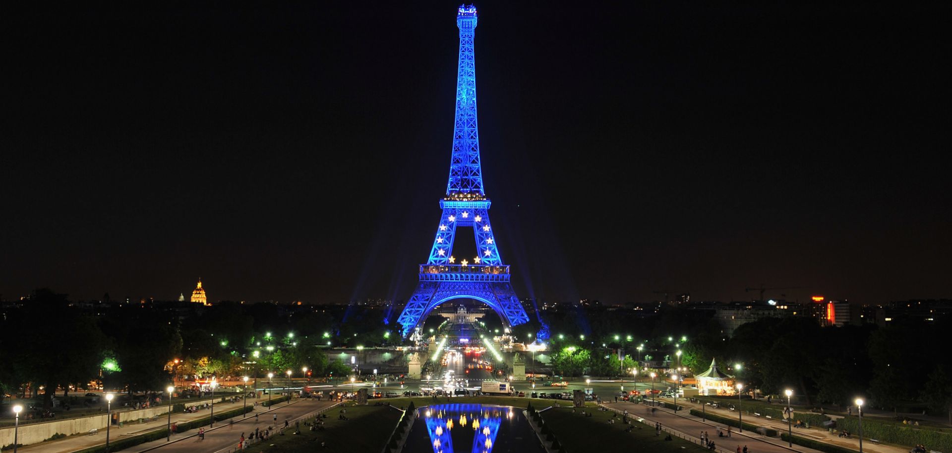 The Eiffel tower is lit with symbols of the European Union, including the stars and blue color that make up the bloc's flag.