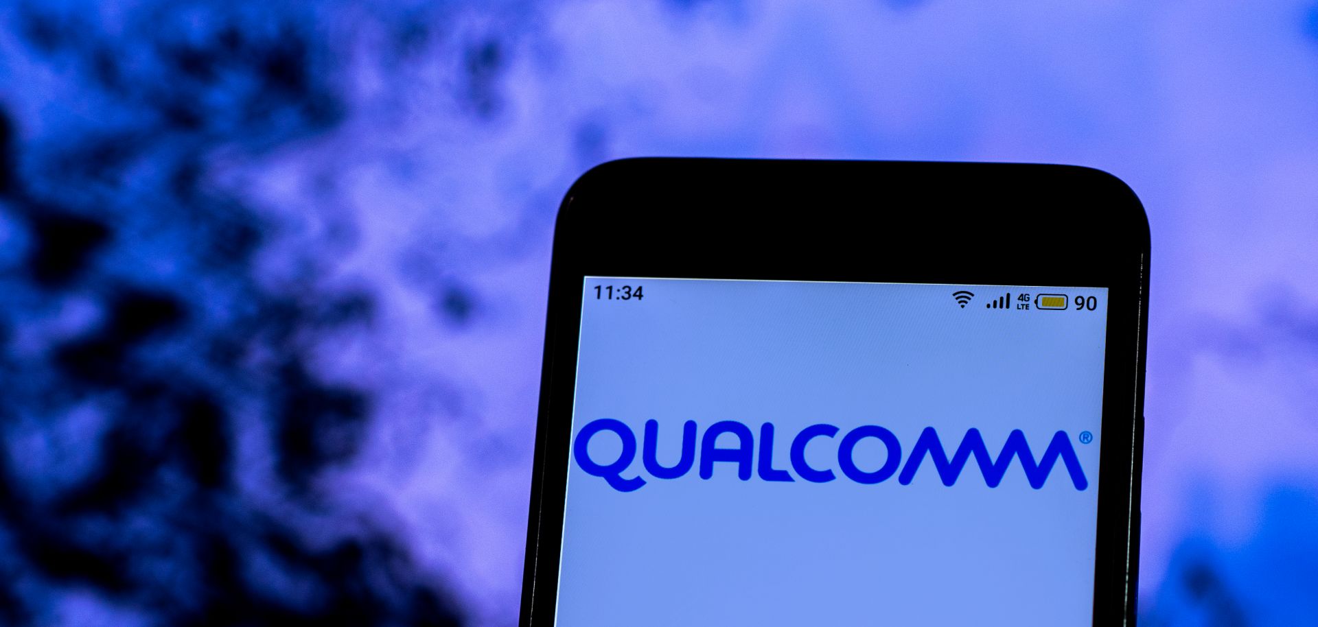 A smartphone displays Qualcomm's company logo.