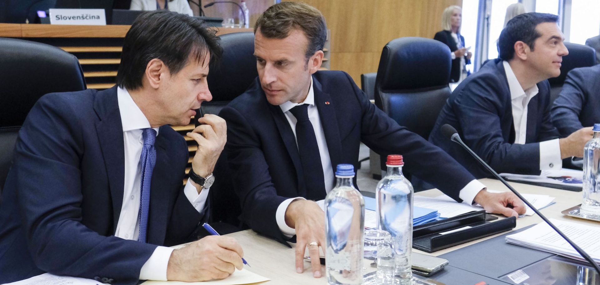 Italian Prime Minister Giuseppe Conte, left, speaks with French President Emmanuel Macron during a summit on migration issues at EU headquarters in Brussels on June 24.