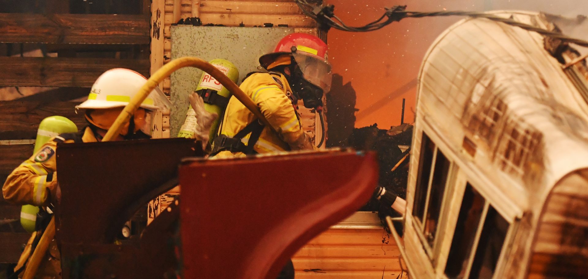 Firefighters put out a fire on a property in Moruya, Australia, on Jan. 23, 2020.