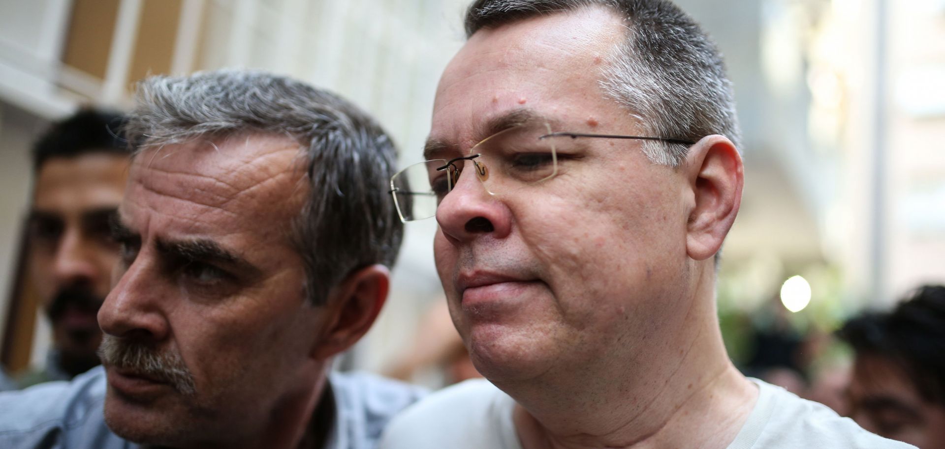 U.S. pastor Andrew Craig Brunson (R), escorted by Turkish plainclothes police officer,s arrives in Izmir, Turkey, July 25.