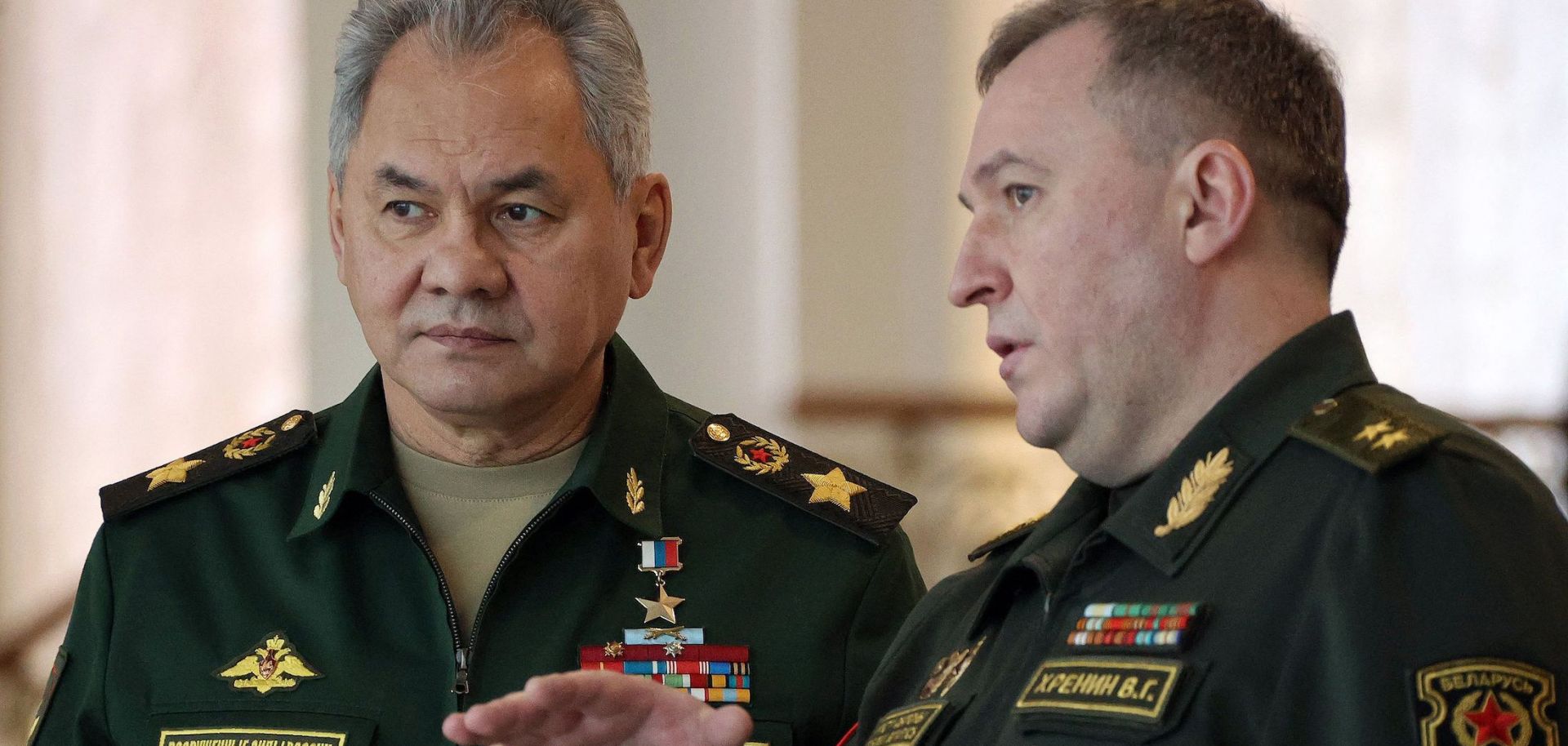 Russian Defense Minister Sergei Shoigu (L) speaks with his Belarusian counterpart, Viktor Khrenin, on Feb. 3, 2022, in Minsk, Belarus.