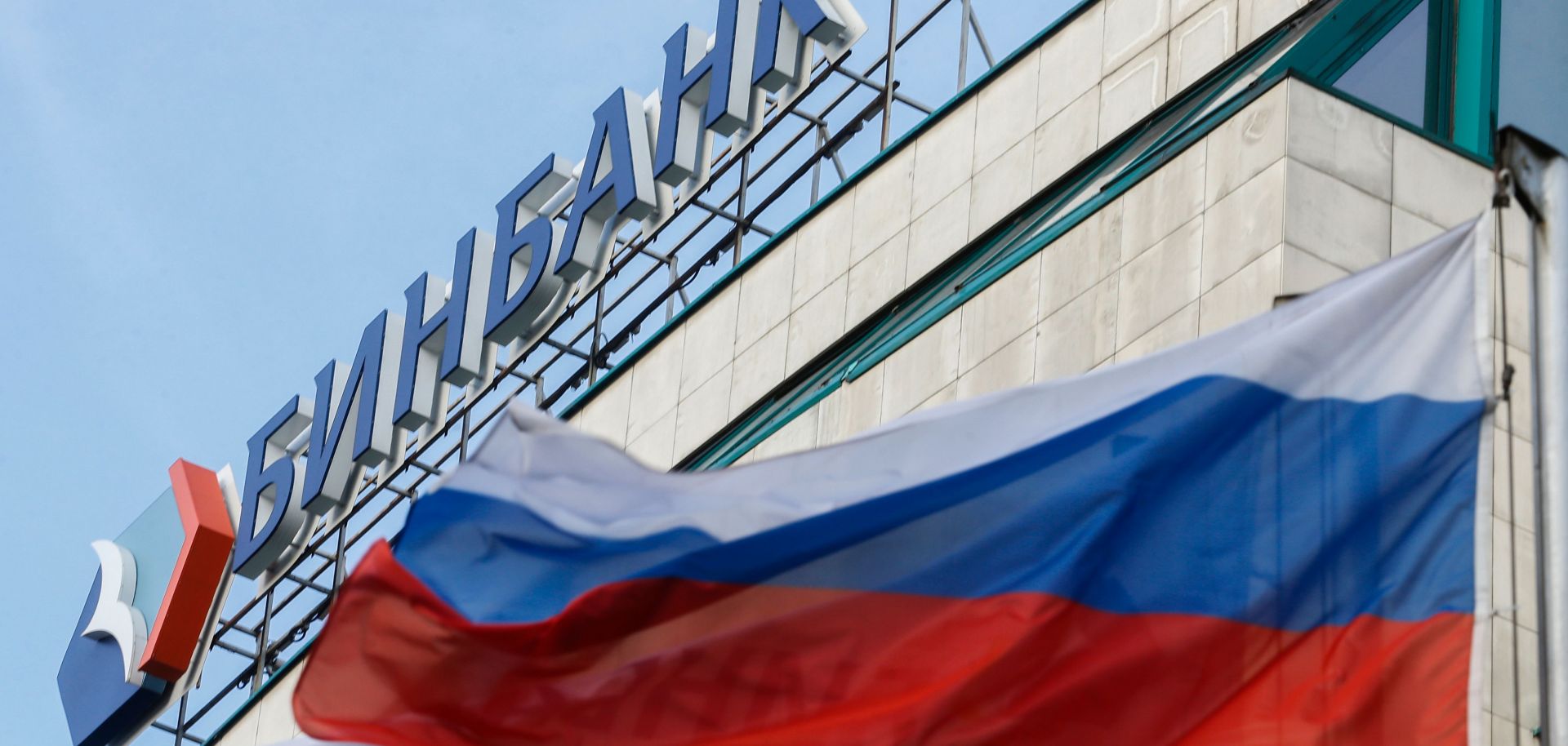 A Russian flag flies next to the headquarters of B&N Bank in downtown Moscow.