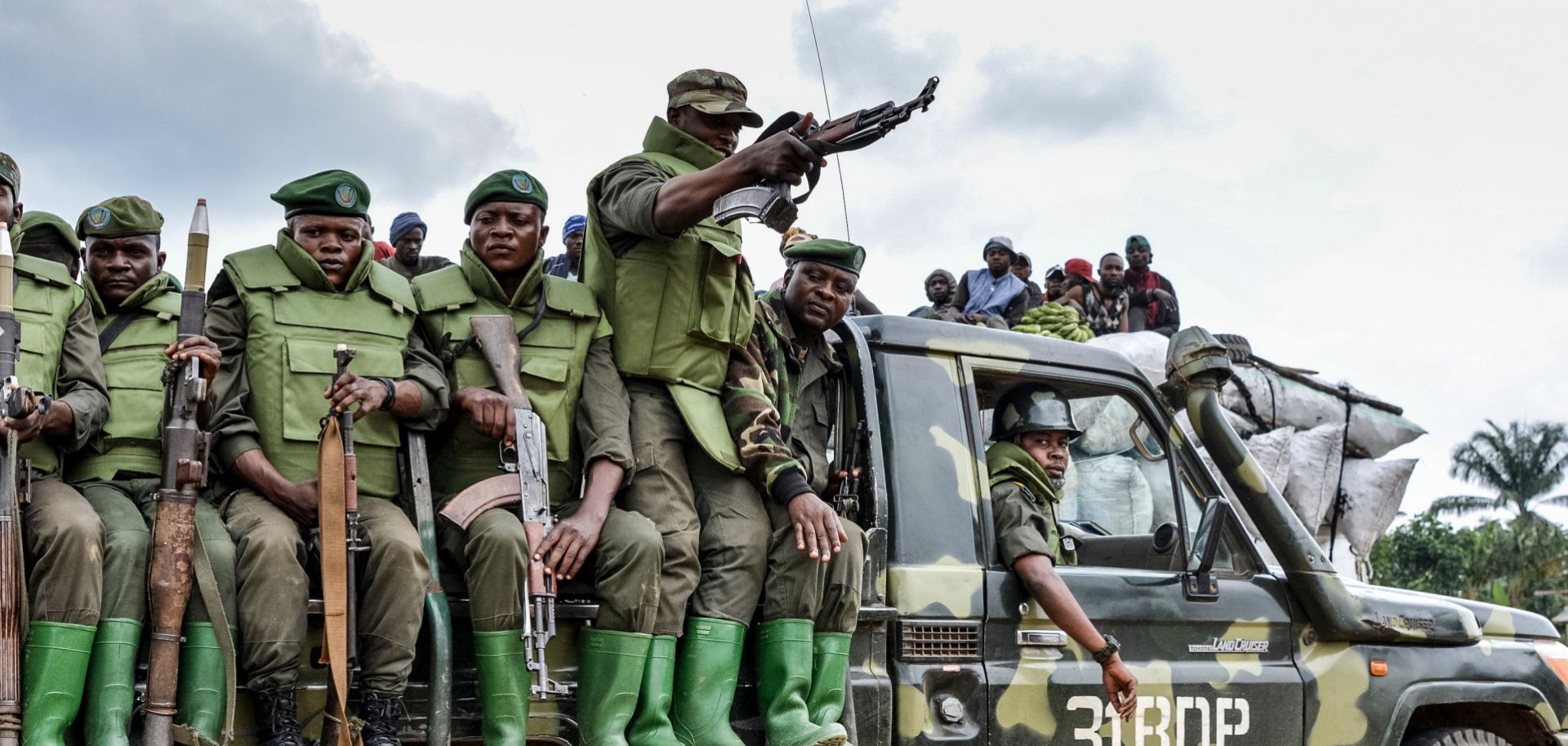 Soldier of the FARDC (Armed Forces of the Democratic Republic of the Congo) sit on a military vehicle.