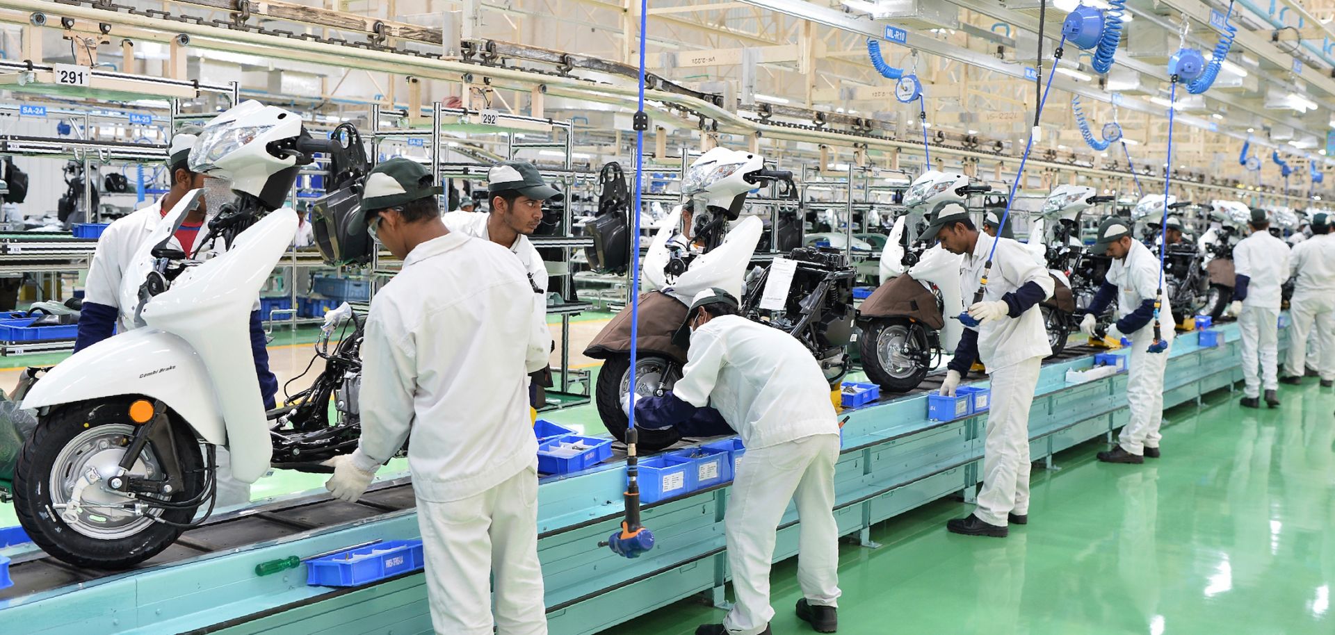 Employees assemble parts and make final inspections of Honda Activa scooters in Narasapura, on the outskirts of Bangalore, India.