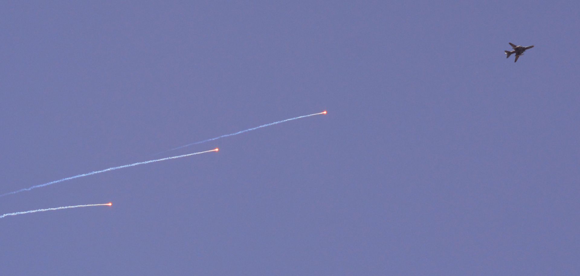 A Syrian air force Sukhoi Su-22 fighter jet flies over the Palestinian camp of Yarmuk on the southern outskirts of Damascus during airstrikes on the Islamic State in April 2018.