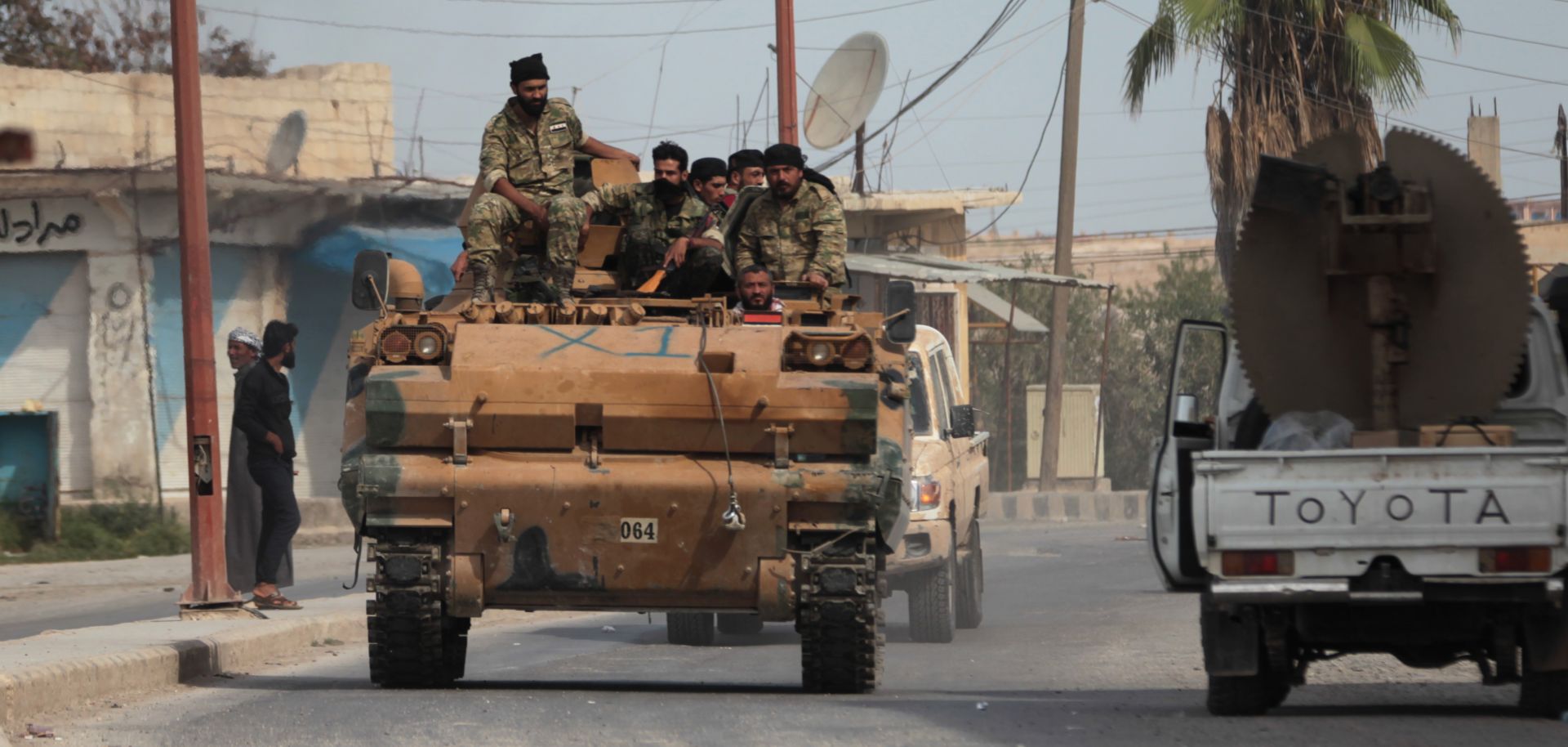 Turkish-backed proxies search for members of the mainly Kurdish Syrian Democratic Forces in Tal Abyad, Syria, on Oct. 15, 2019.