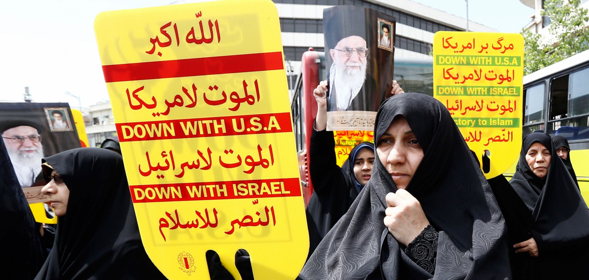 Iranian demonstrators raise placards and portraits of Iran's Supreme Leader Ayatollah Ali Khamenei as they chant anti-US slogans during a rally in the capital Tehran, on May 10 2019.