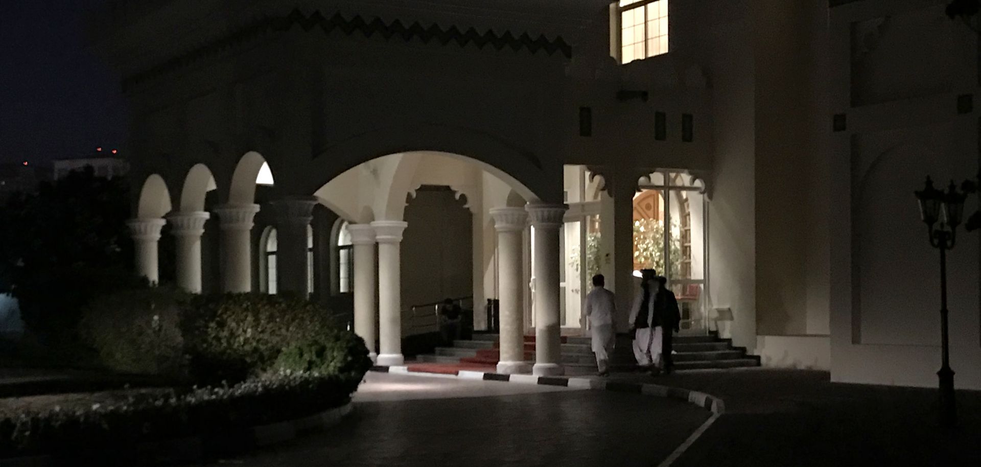 Members of the Taliban negotiating team enter the venue in Doha