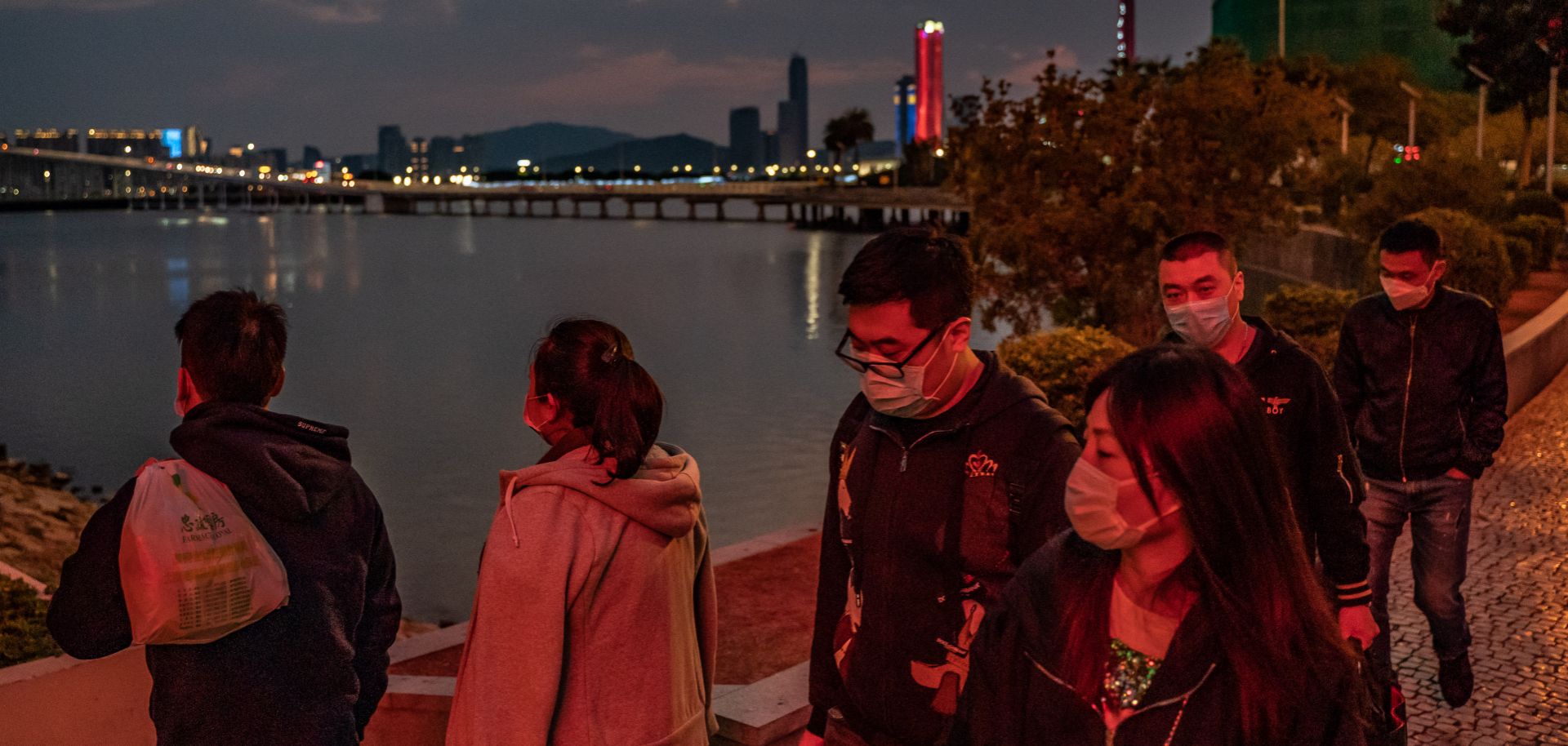 People wear masks against a new coronavirus while walking in Macau on Jan. 28, 2020.