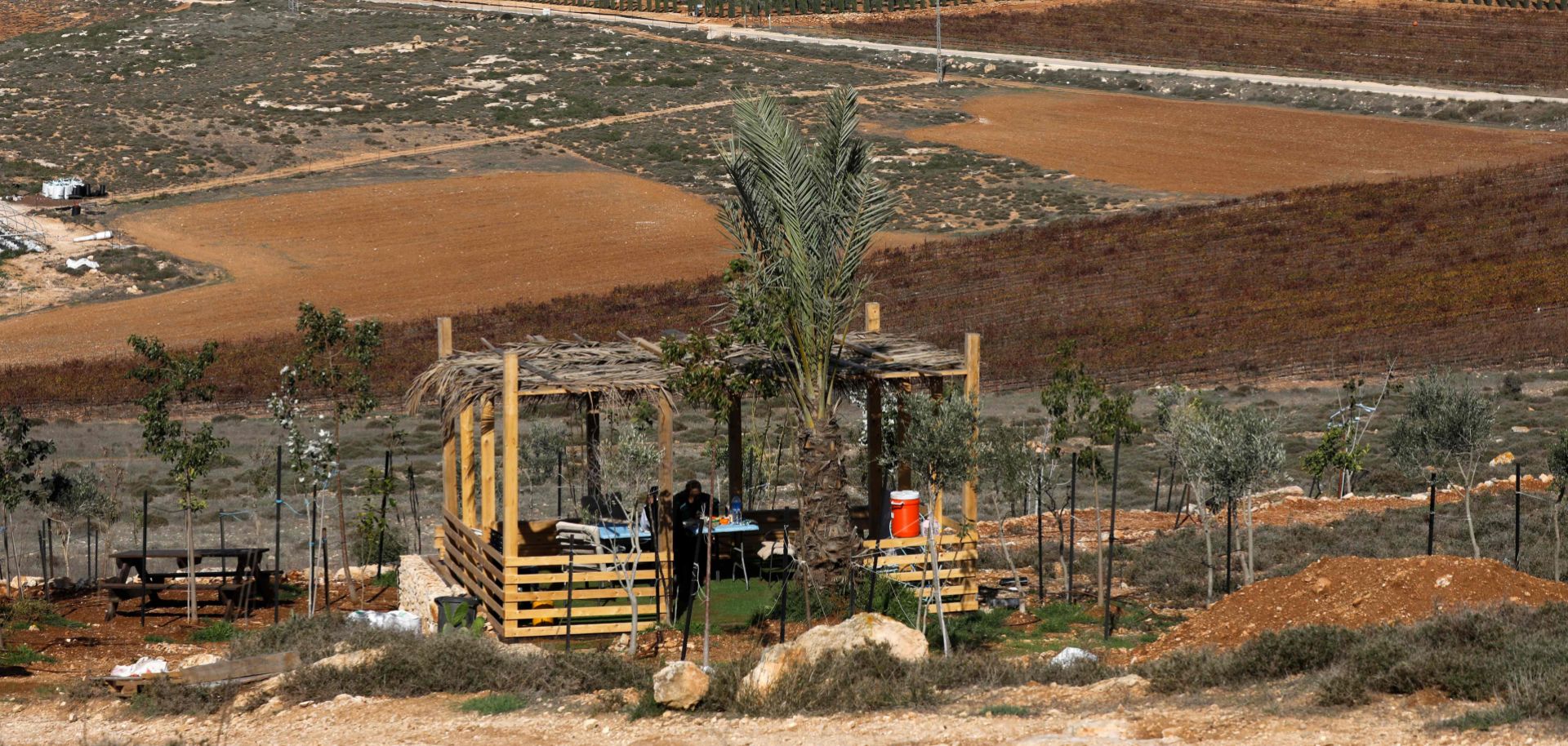 Settlers sit in a shack north of the Palestinian village of al-Mughayyir near the Israeli settlement of Shilo in the occupied West Bank on Nov. 20, 2018.