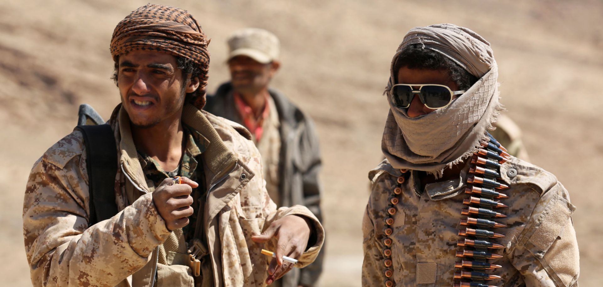 Yemeni fighters loyal to internationally recognized President Abd Rabboh Mansour Hadi stand guard near Sanaa, the capital city, in February 2018.