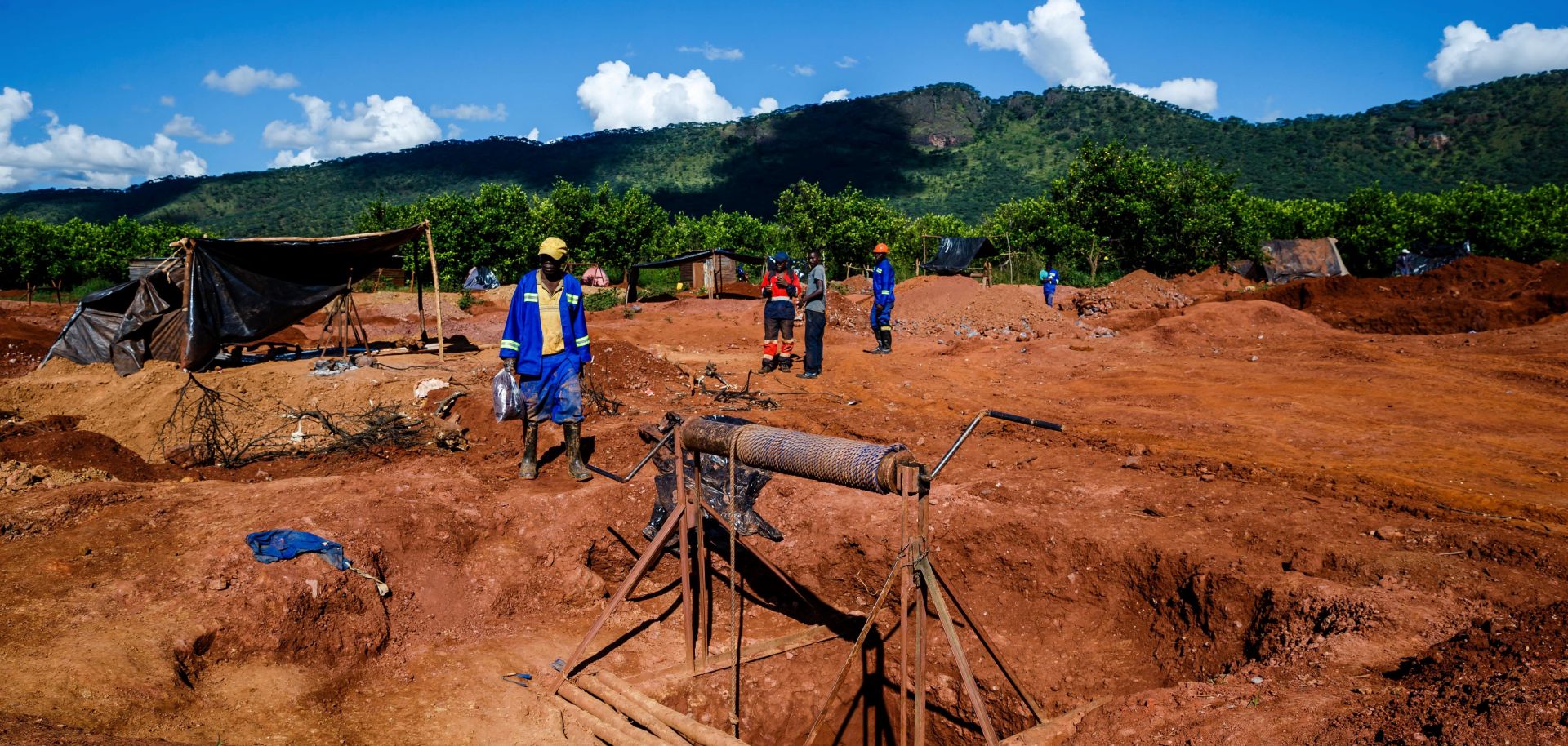 Miners walk near a mine shaft at Manzou Farm, owned by Grace Mugabe, wife of former Zimbabwean President Robert Mugabe, in Mazowe, Zimbabwe, on April 5, 2018.