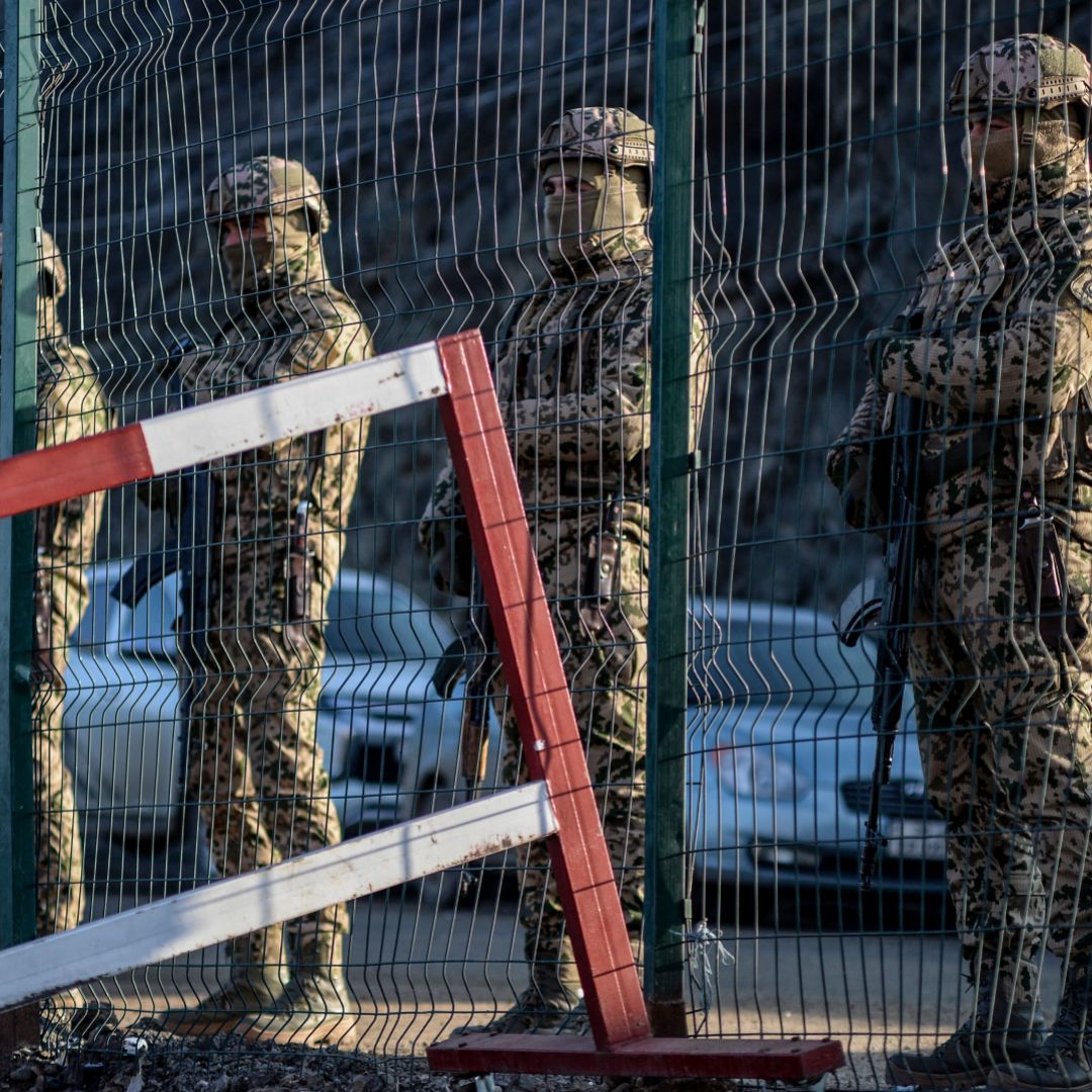 Azeri soldiers stand guard at a checkpoint at the Lachin corridor, the disputed Nagorno-Karabakh region's only land link with Armenia, on Dec. 27, 2022. 