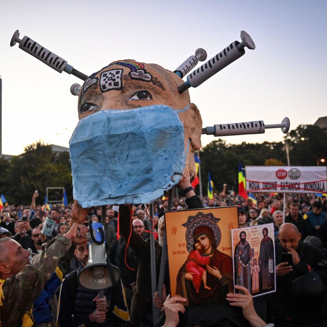 People take part in a protest against COVID-19 vaccines and lockdown measures in Bucharest, Romania, on Oct. 2, 2021.  