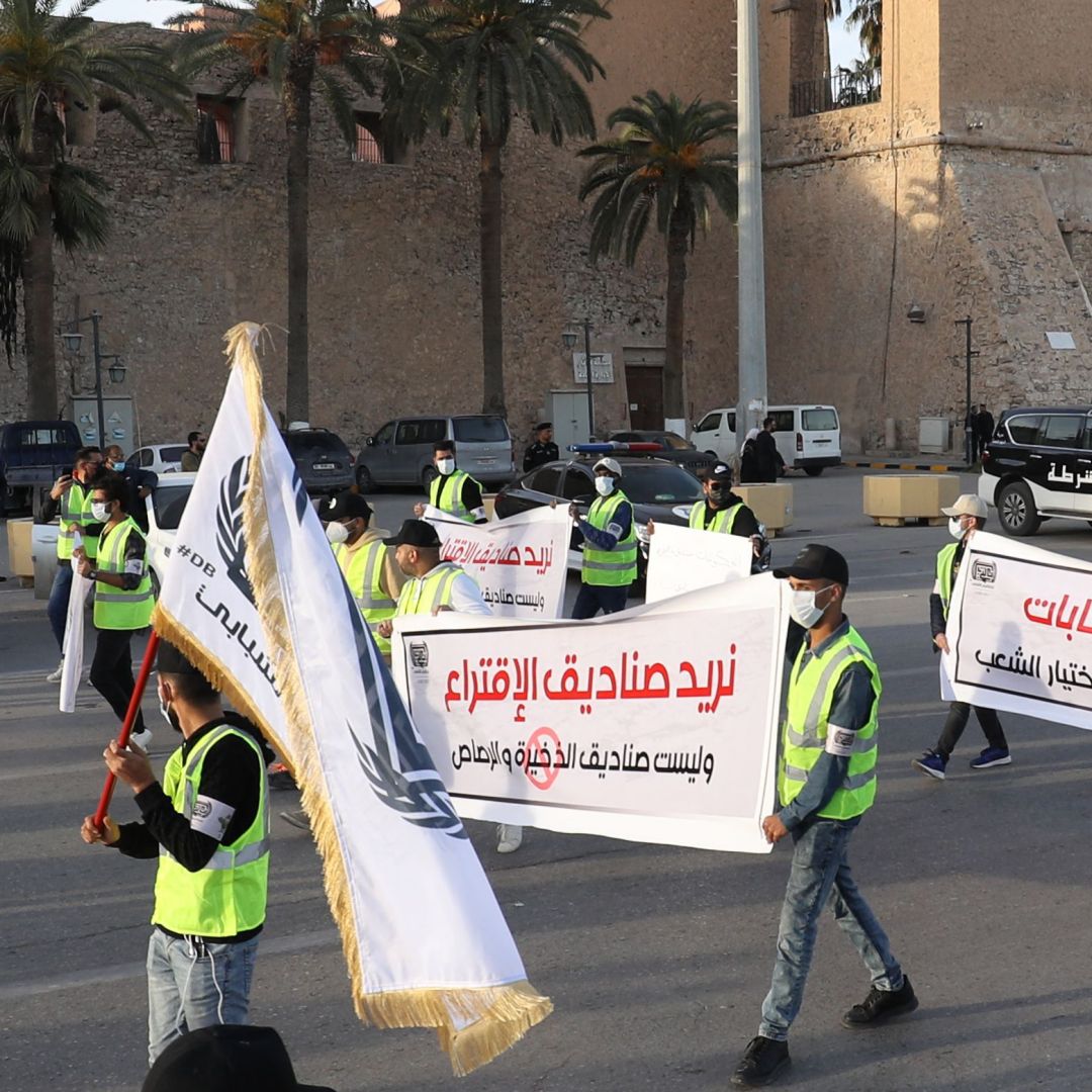 A group of activists protest against the postponement of Libya’s presidential election in Tripoli's Martyrs Square on Dec. 25, 2021.  