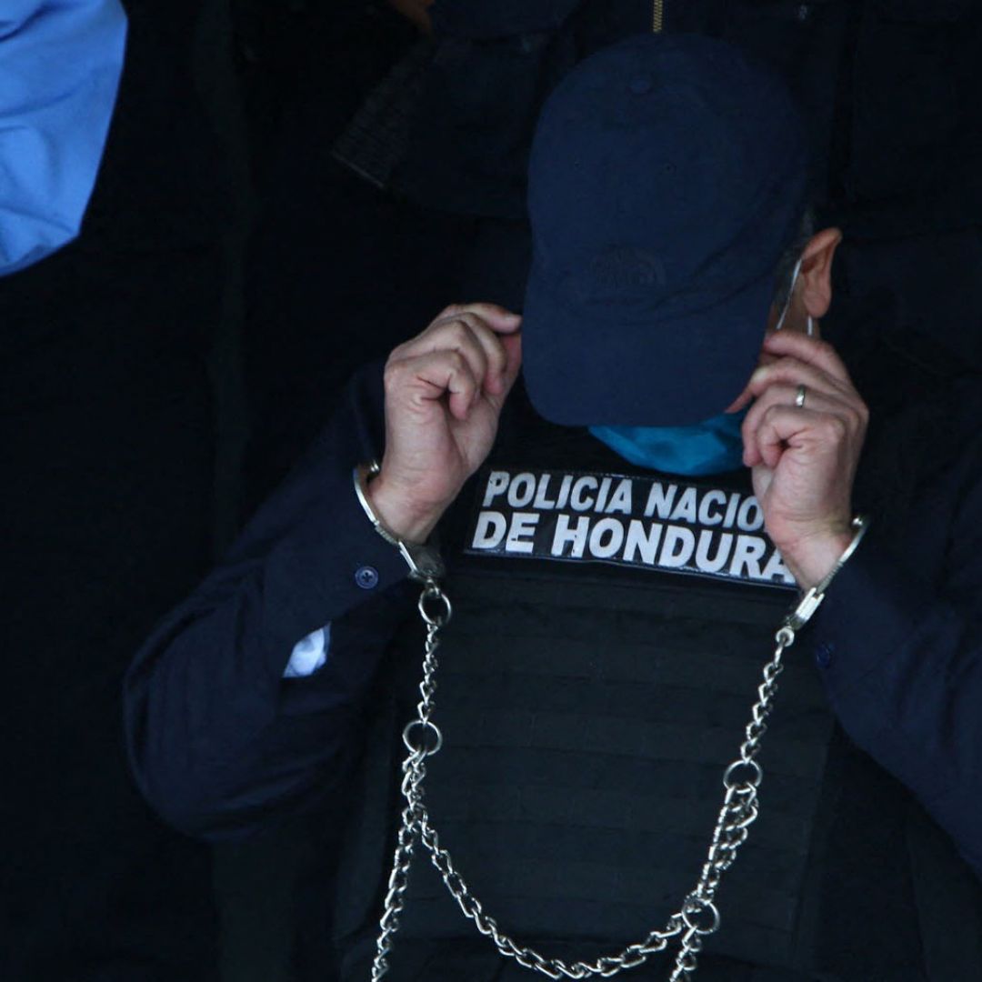 Juan Orlando Hernandez, the former president of Honduras, is seen handcuffed at the headquarters of the country’s police force in Tegucigalpa on Feb. 15, 2022. He was arrested after receiving an extradition order from the United States. 