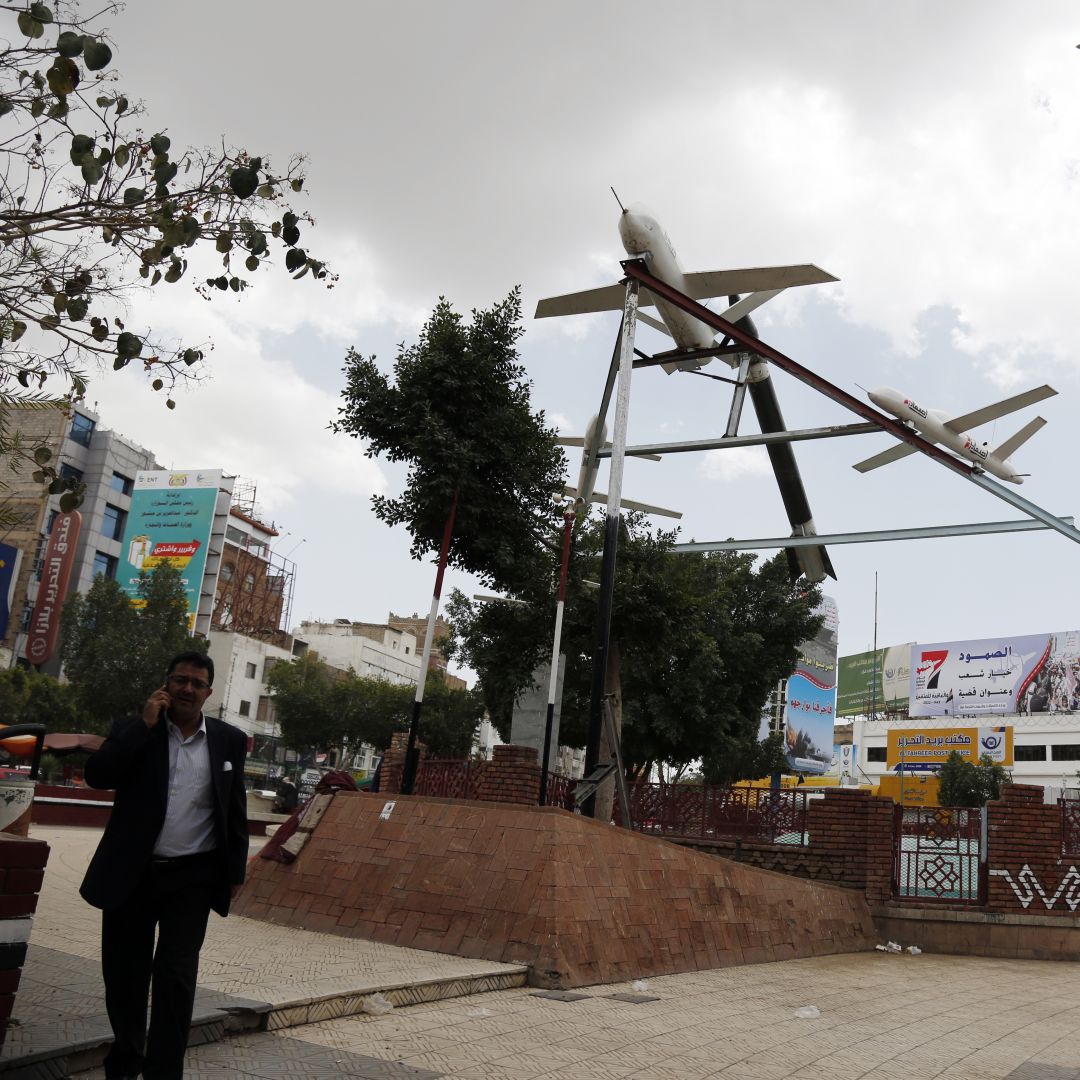 A photo taken in Sanaa, Yemen, on March 21, 2022, shows people walking under mock drones and missiles set up by supporters of the country's Iran-aligned Houthi movement, which earlier conducted attacks against Saudi energy facilities. A photo taken in Sanaa, Yemen, on March 21, 2022, shows people walking under mock drones and missiles set up by supporters of the country's Iran-aligned Houthi movement, which earlier conducted attacks against Saudi energy facilities.