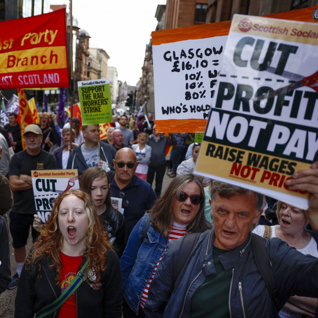 Supporters of the National Union of Rail, Maritime and Transport Workers (RMT) protest in Glasgow, Scotland, on July 27, 2022, as part of a nationwide strike among U.K. rail workers. 