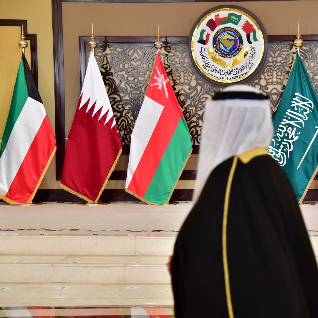 A man walks past the flags of the countries attending the Gulf Cooperation Council (GCC) summit in Kuwait City, Kuwait, on Dec. 5, 2017. 