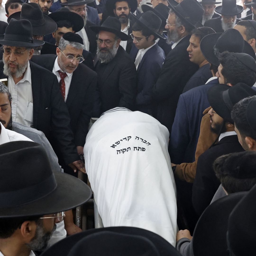 Mourners attend the funeral of Yaakov Shalom, one of the five people killed in yesterday's shooting attack in the religious town of Bnei Brak, at the Yarkon cemetery in the Israeli city of Petah Tikva on March 30, 2022. Mourners attend the funeral of Yaakov Shalom, one of the five people killed in yesterday's shooting attack in the religious town of Bnei Brak, at the Yarkon cemetery in the Israeli city of Petah Tikva on March 30, 2022.