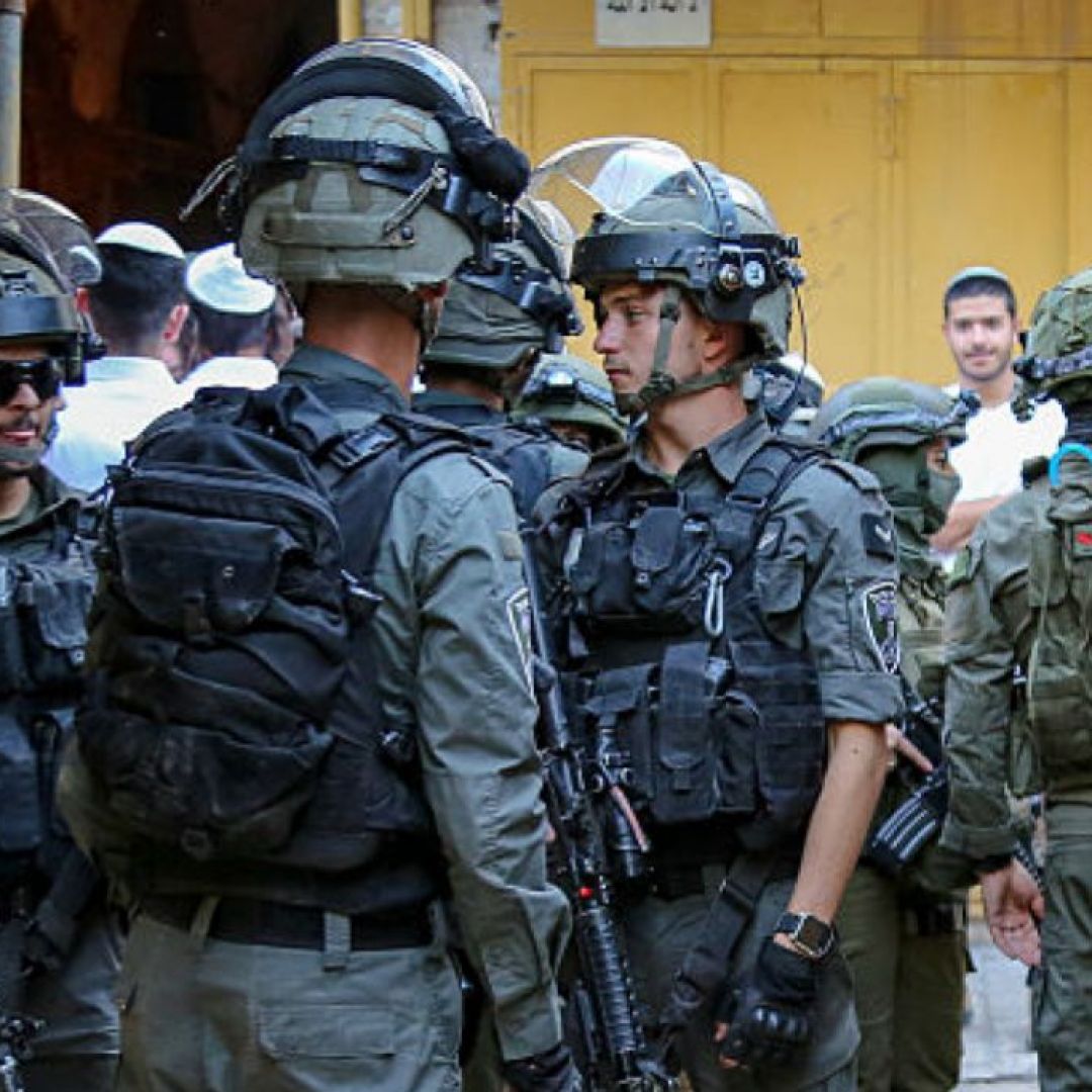 A group of armed Israeli soldiers stands in a narrow alley of the Old City of Hebron, West Bank, on May 31, 2025. A group of armed Israeli soldiers stands in a narrow alley of the Old City of Hebron, West Bank, on May 31, 2025.