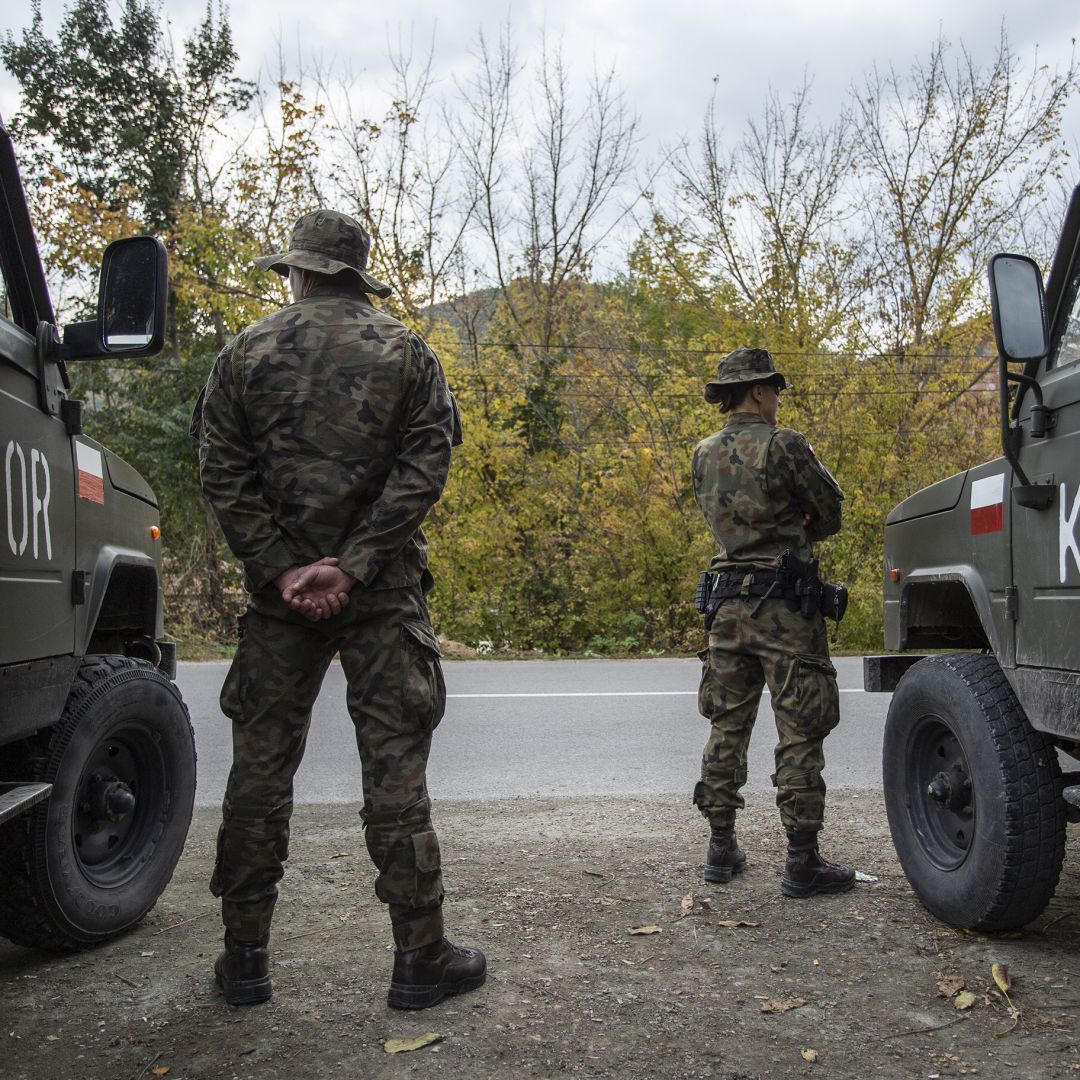 NATO soldiers patrol a road near the town of Zvecan in northern Kosovo on Oct. 12, 2022.