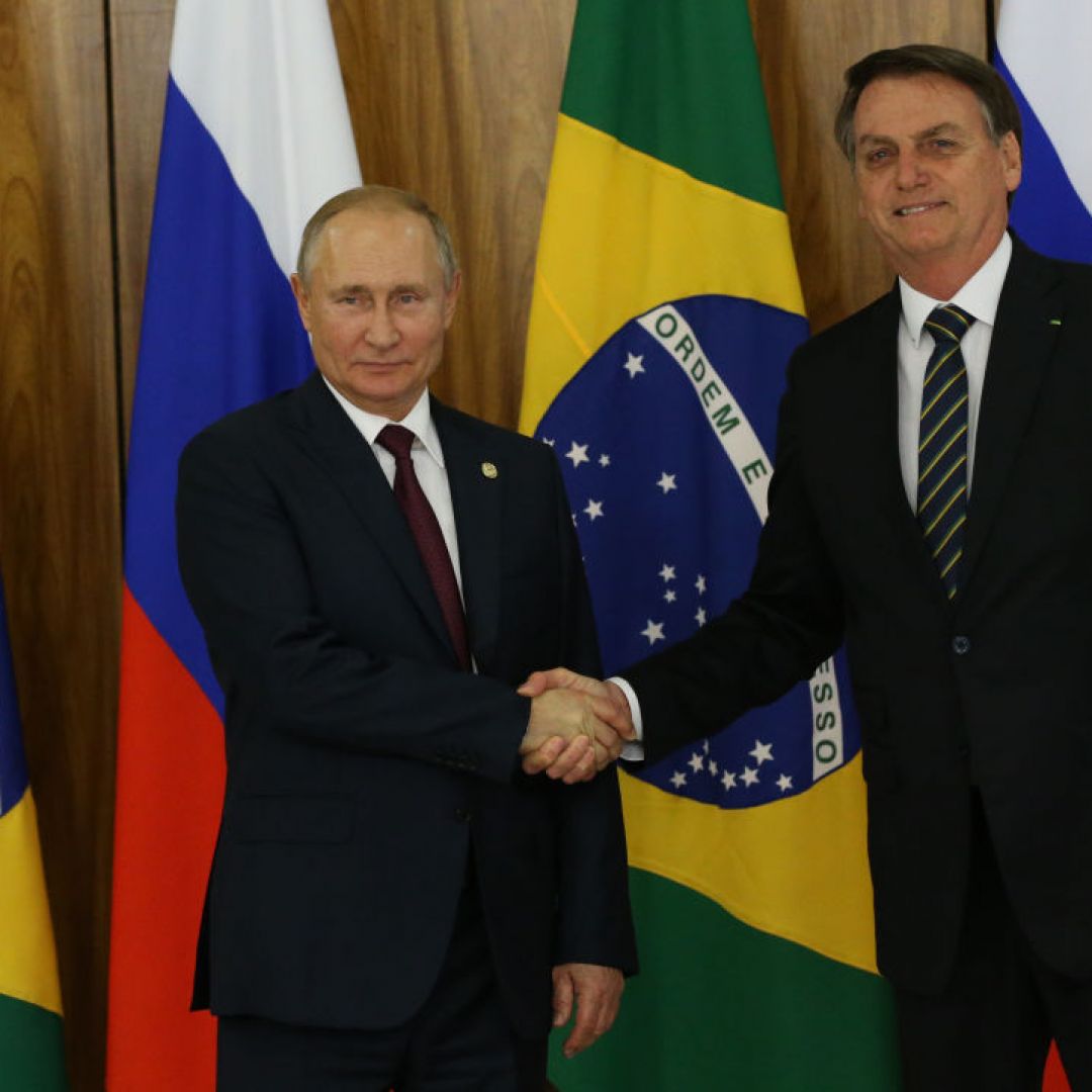 Russian President Vladimir Putin (L) greets Brazilian President Jair Bolsonaro on Nov. 14, 2019, in Brasilia, Brazil, on the sidelines of a BRICS summit.