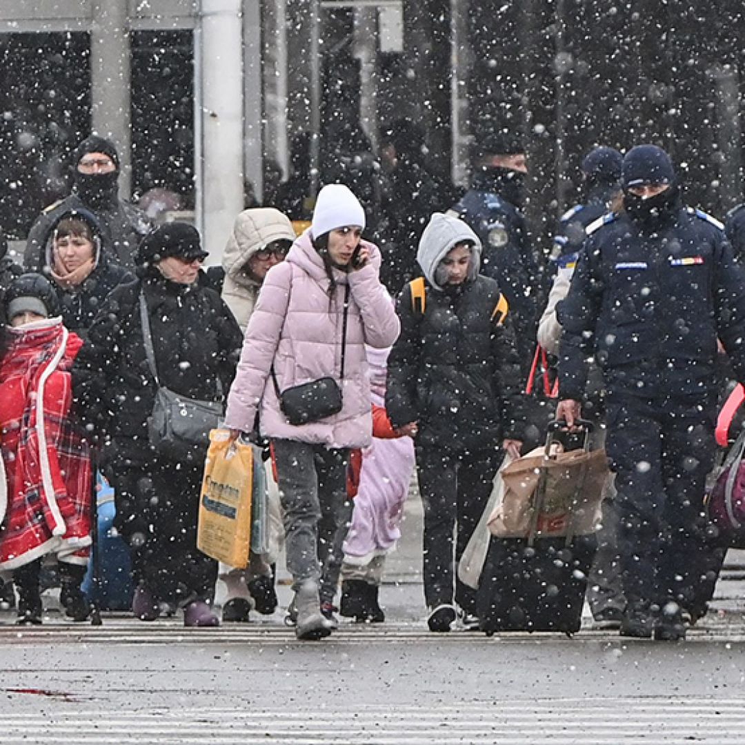 Refugees from Ukraine walk at the Ukrainian-Romanian border in Siret on March 2, 2022.