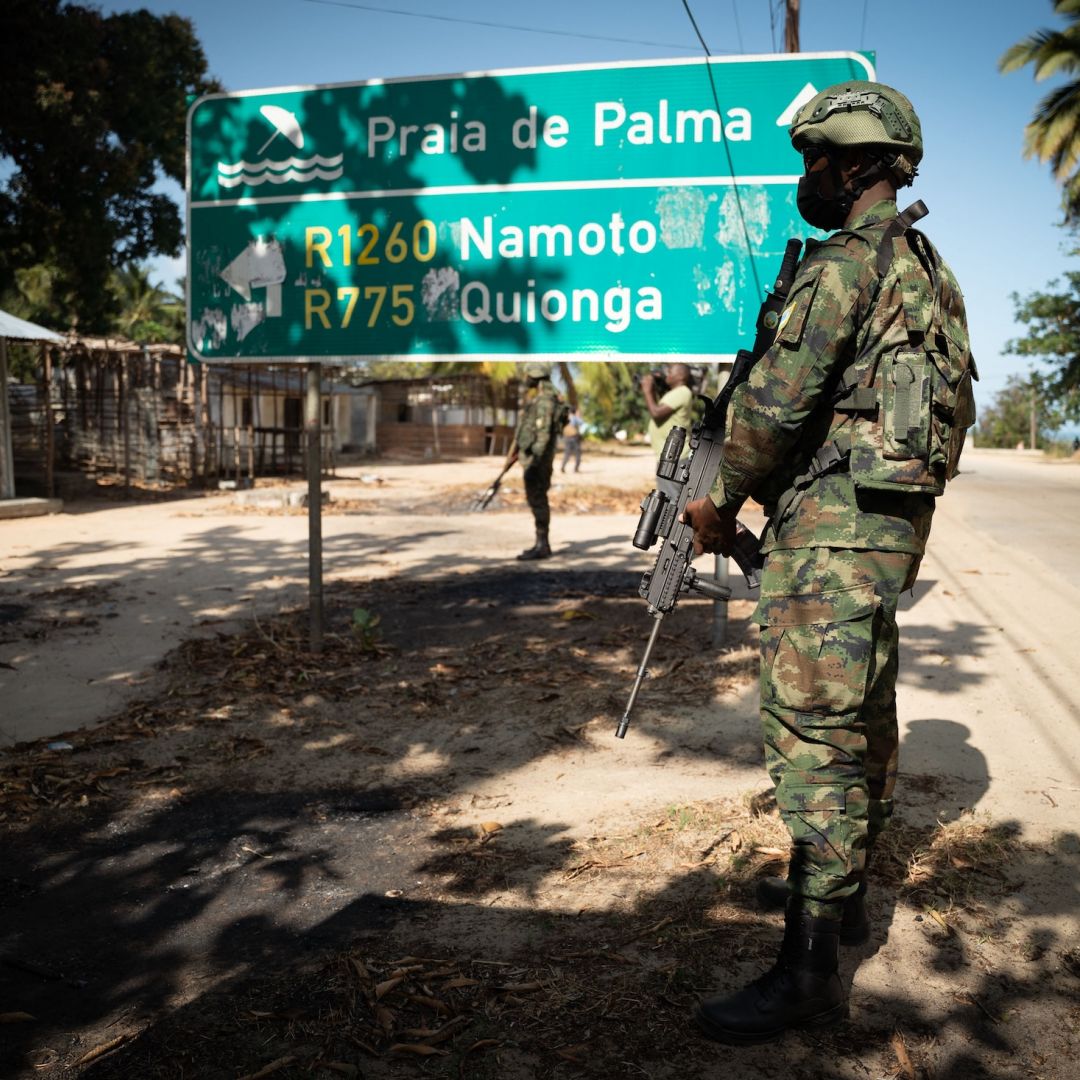 A Rwandan soldier walks in front of a burned truck near Palma in Mozambique’s Cabo Delgado region on Sept. 22, 2021. 