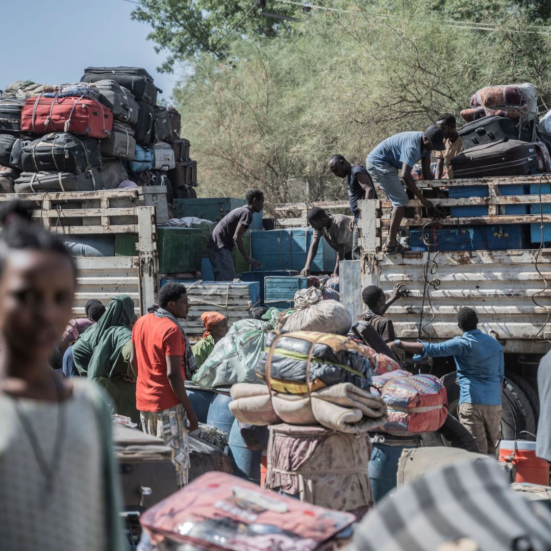 Workers load luggage onto a vehicle that belongs to refugees from Sudan who entered Ethiopia in Metema on May 5, 2023.