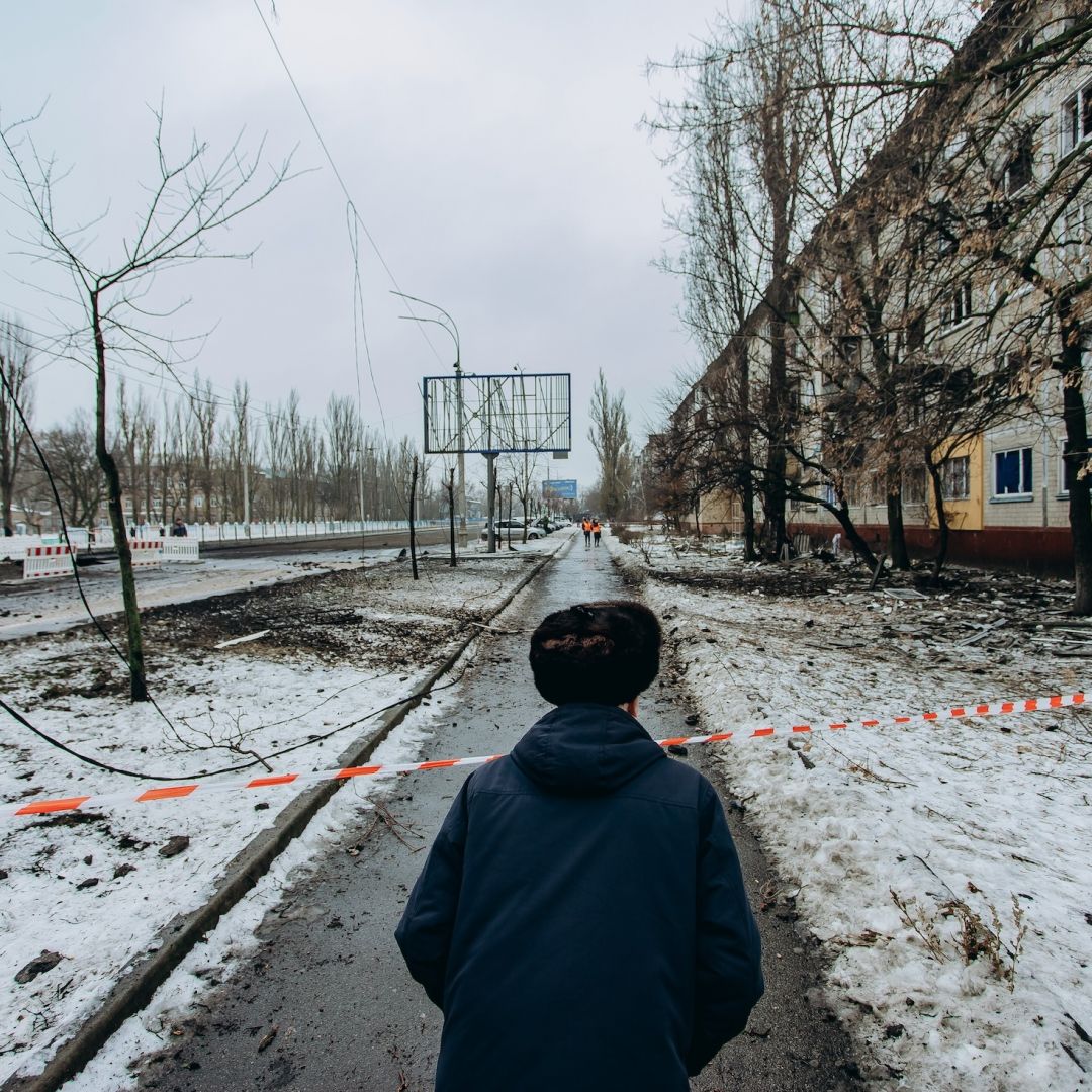 A man looks at the road blocked by striped tape on December 13, 2023, in Kyiv, Ukraine, following two nights of ballistic missile attacks on the city.