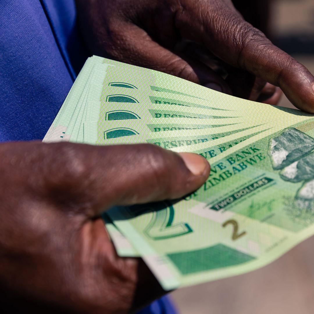 A man displays his new two-dollar notes of the Zimbabwe dollar.