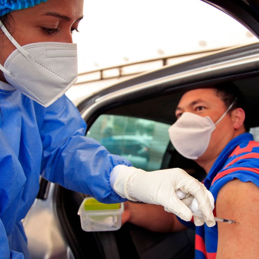 A man receives a dose of a COVID-19 vaccine at a drive-through distribution site in Bogota, Colombia, on April 11, 2021.