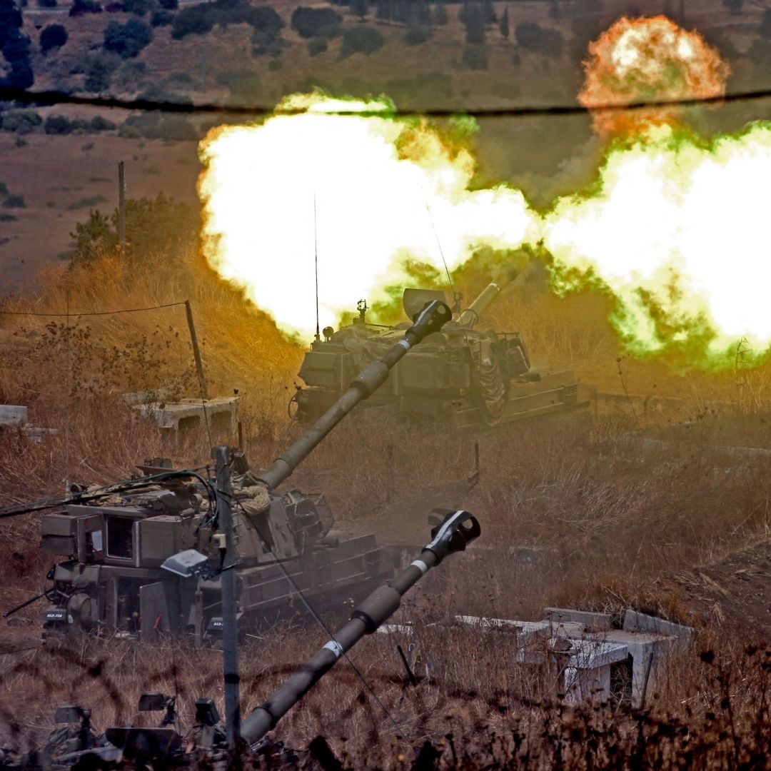 Israeli self-propelled howitzers fire toward Lebanon on Aug. 6, 2021, from a position near the northern Israeli town of Kiryat Shmona following rocket fire from the Lebanese side of the border.