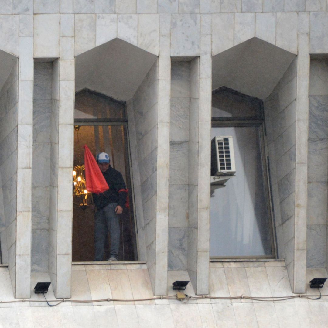 A protester is seen in the window of the seized main government building, known as the White House, in Bishkek, Kyrgyzstan, on Oct. 6, 2020. 