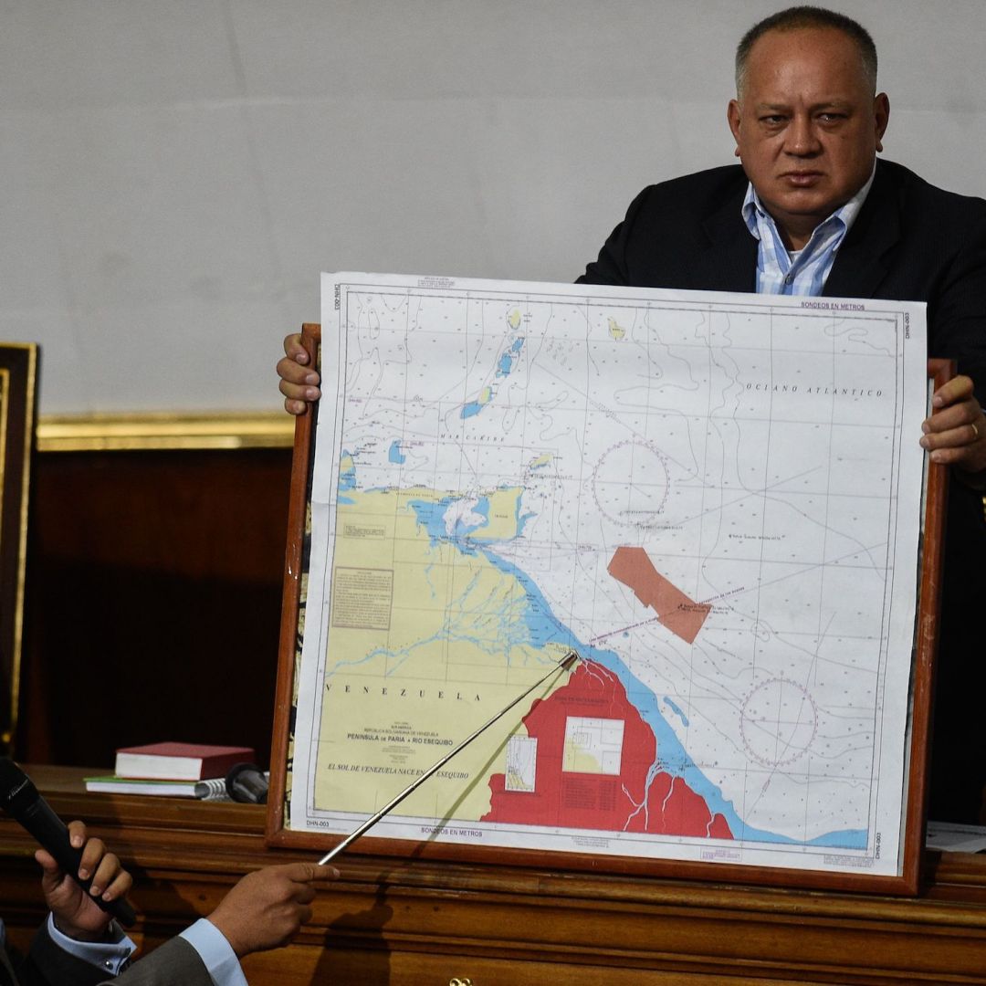 Venezuelan lawmaker Pedro Carreno (L) delivers a speech while Venezuelan deputy Diosdado Cabello (R) holds a map showing the border between Venezuela and Guyana during a legislative session in Caracas on Jan. 8, 2019.