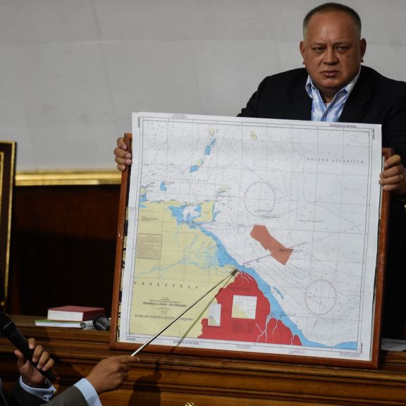 Venezuelan lawmaker Pedro Carreno (L) delivers a speech while Venezuelan deputy Diosdado Cabello (R) holds a map showing the border between Venezuela and Guyana during a legislative session in Caracas on Jan. 8, 2019. Venezuelan lawmaker Pedro Carreno (L) delivers a speech while Venezuelan deputy Diosdado Cabello (R) holds a map showing the border between Venezuela and Guyana during a legislative session in Caracas on Jan. 8, 2019.